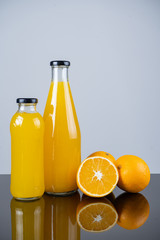 Bottle of orange juice and oranges