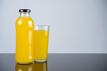 Bottle of orange juice and oranges