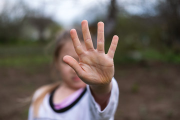 Girl making stop gesture with hand. Social distancing, quarantine, self-isolation, lifestyle concept.