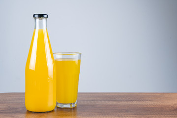 Bottle of orange juice and oranges