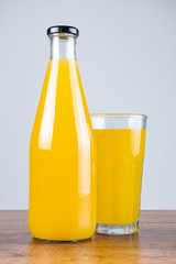 Bottle of orange juice and oranges