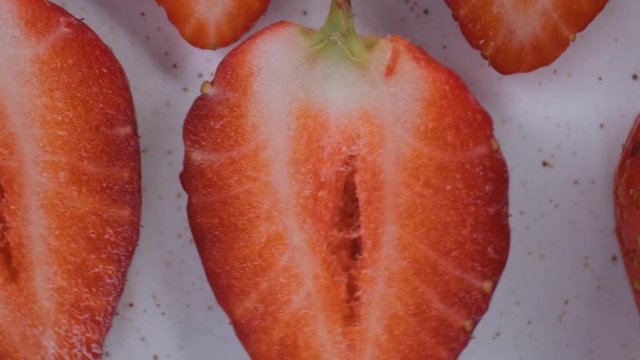 beautiful ripe strawberry close-up,sliced strawberry rotating,fruit macroshooting,healthy food and diet concept,source of vitamins,isolated half strawberry on white background rotates
