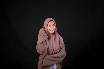 Portrait of Young Asian Islam woman wearing headscarf looking at camera and smiling happy expression