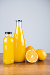 Bottle of orange juice and oranges