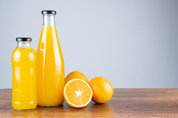 Bottle of orange juice and oranges