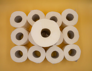 White toilet paper for the bathroom with yellow background
