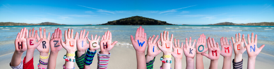 Children Hands Building Colorful German Word Herzlich Willkommen Means Welcome. Ocean And Beach As...