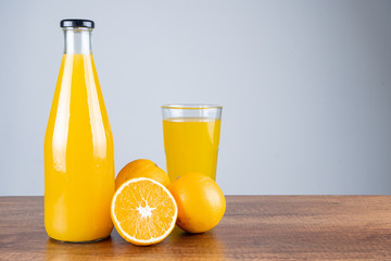 Bottle of orange juice and oranges