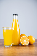 Bottle of orange juice and oranges