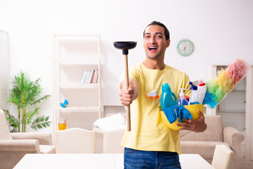 Young male contractor doing housework at home
