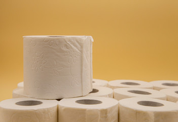White toilet paper for the bathroom with yellow background