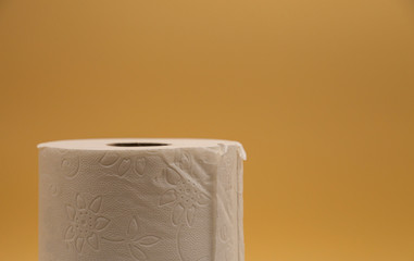 White toilet paper for the bathroom with yellow background