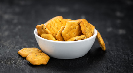 Mixed Snacks on dark background (close up shot; selective focus)