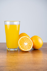 glass of orange juice and orange