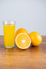 glass of orange juice and orange