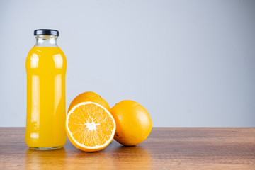 glass of orange juice and orange
