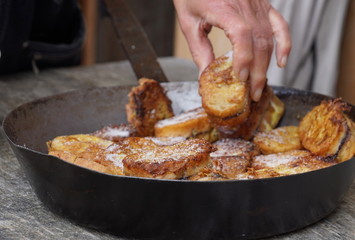 Traditional Austrian desert „Pofesen“ (french toast with sugar and plum jam) served in an iron pan on an alpine hut