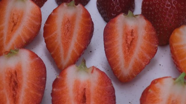 beautiful ripe strawberry close-up,sliced strawberry rotating,fruit macroshooting,healthy food and diet concept,source of vitamins,isolated half strawberry on white background rotates