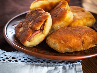 Homemade ham pies on a brown plate on a cotton napkin