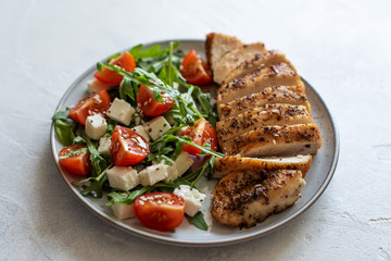 Close-up on a salad with chicken and tomato