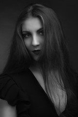 Black and white portrait of young fat girls brunette with long hairblack dress with sweetheart neckline