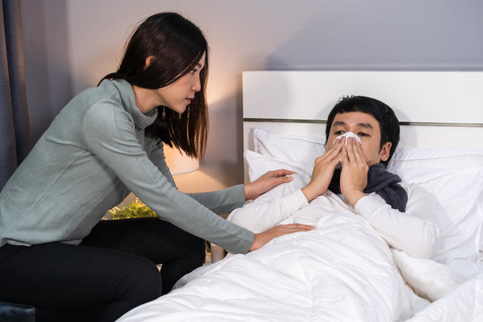 wife visiting and take care her sick husband while he lying on bed at home