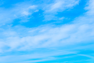 Blue sky with white clouds, textured background
