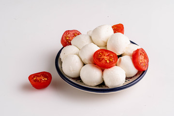 mozzarella with cherries in white bowl