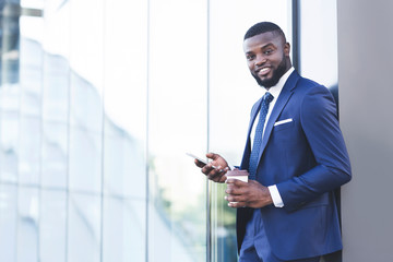 Business Guy Texting On Cellphone Standing Outdoors In Urban Area