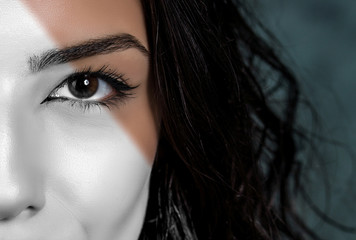 Fototapeta premium Close-up photo of woman eye with eyeliner makeup. Colorful, black and white. Creative concept.