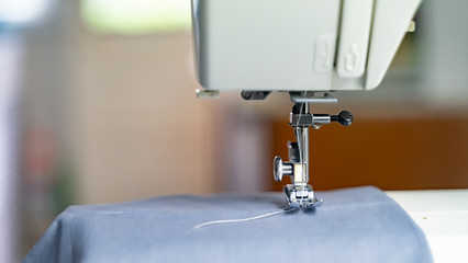 Electric sewing machine with fabric and thread