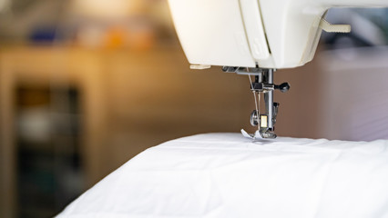 Electric sewing machine with fabric and thread