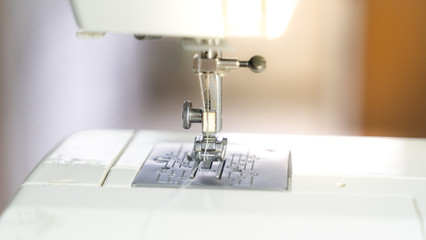 Electric sewing machine with fabric and thread