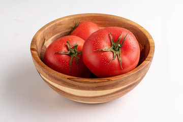 tomatoes in wooden bowl