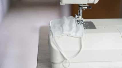 Electric sewing machine with fabric and thread