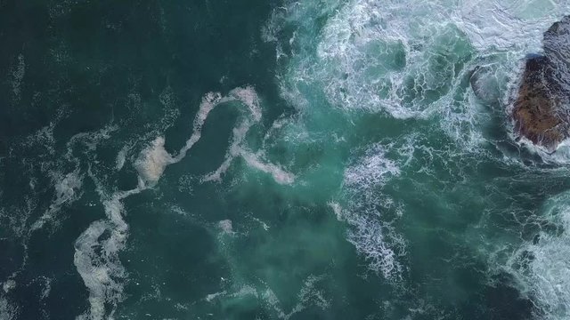 Cinematic aerial descending flight over turquoise blue ocean waves rolling, beautiful zoom in seascape scene