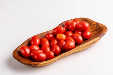 cherry tomatoes on wooden plate