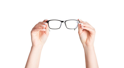 Closeup of young woman holding eyeglasses on white background. Panorama