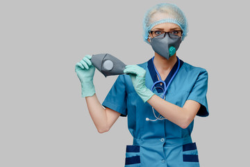 female doctor with stethoscope wearing protective mask and latex gloves over light grey background