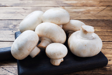Fresh mushrooms champignons on a wooden background. Close-up Space for text.