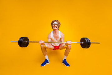 Full length body size view of nice funky motivated weak guy lifting barbell doing work out coacher...