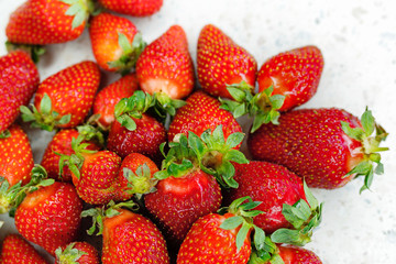 Freshly picked strawberries from the home garden. Natural organic food production. Heap of summer red berries. Homegrown, gardening and agriculture concept. Close up. Soft focus