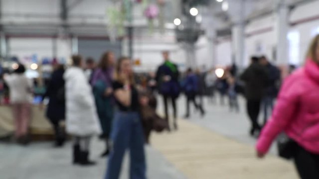 Defocused, blurred image of a crowd of people. Flea market, hangar fair, garage sale.