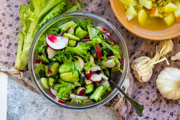 Fresh vegetables salad - radish, lettuce, cucumber, salad leaves. Vegan healthy food