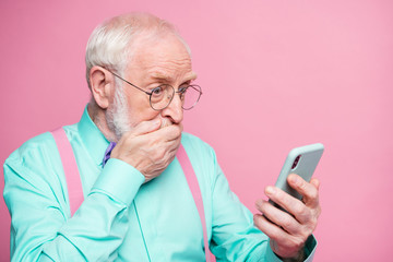 What.... unbelievable. Frustrated anxious old man use smartphone read social network notification...