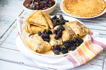 Baked french crepes, thin pancakes with sweet mulberry filling