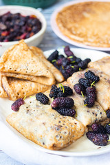 Baked french crepes, thin pancakes with sweet mulberry filling
