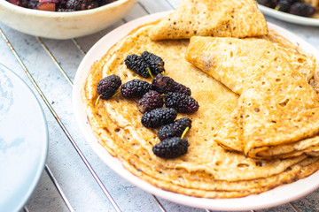 Baked french crepes, thin pancakes with sweet mulberry filling