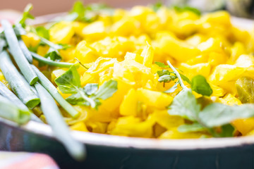 Vegetables stew with potato and cabbage and herbs - rucola and onion sprout. Vegan food.