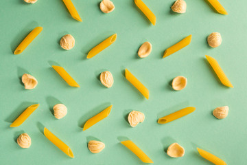 Pasta penne pattern on a colorful mint background. Repetition concept.